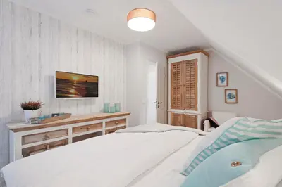 Ein Bett oder Betten in einem Zimmer der Unterkunft Mondmuschel