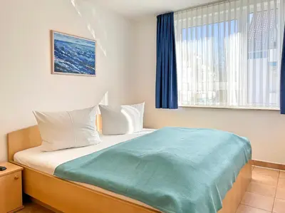 Ein Bett oder Betten in einem Zimmer der Unterkunft Residenz am Strand, Whg 352