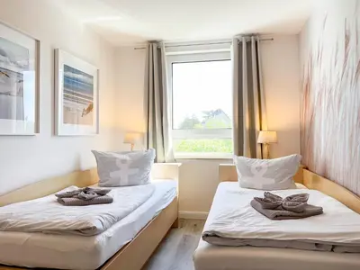 Ein Bett oder Betten in einem Zimmer der Unterkunft Residenz am Strand, Whg 677
