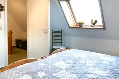 Ein Bett oder Betten in einem Zimmer der Unterkunft Windflüchter 2