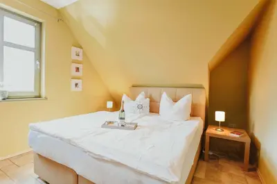 Ein Bett oder Betten in einem Zimmer der Unterkunft Ferienwohnung Am Leuchtfeuer OG LF 7 2