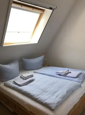 Ein Bett oder Betten in einem Zimmer der Unterkunft Strandmuschel