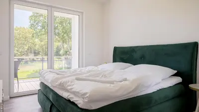 Ein Bett oder Betten in einem Zimmer der Unterkunft Apartmenthaus Wittsande Wittsande 07