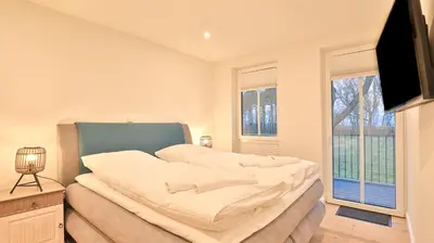 Ein Bett oder Betten in einem Zimmer der Unterkunft Strandhaus Zingst Apartment 08