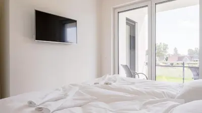 Ein Bett oder Betten in einem Zimmer der Unterkunft Apartmenthaus Wittsande Wittsande 02
