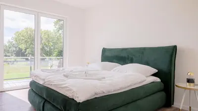 Ein Bett oder Betten in einem Zimmer der Unterkunft Apartmenthaus Wittsande Wittsande 03