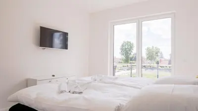 Ein Bett oder Betten in einem Zimmer der Unterkunft Apartmenthaus Wittsande Wittsande 03
