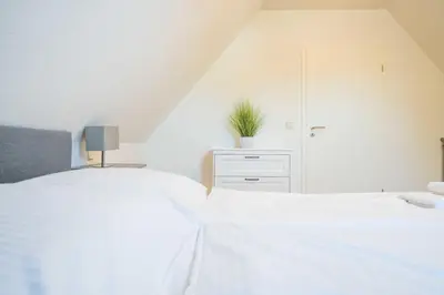 Ein Bett oder Betten in einem Zimmer der Unterkunft Windflüchter Brise