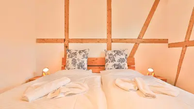 Ein Bett oder Betten in einem Zimmer der Unterkunft Mühlenhaus Tretmühle