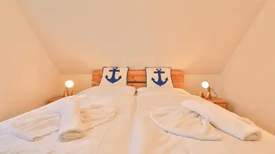Ein Bett oder Betten in einem Zimmer der Unterkunft Mühlenhaus Windmühle