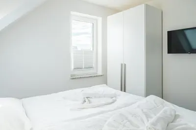 Ein Bett oder Betten in einem Zimmer der Unterkunft Dünenquartier Apartment 08