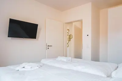 Ein Bett oder Betten in einem Zimmer der Unterkunft Dünenquartier Apartment 09