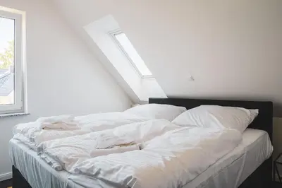 Ein Bett oder Betten in einem Zimmer der Unterkunft Dünenquartier Apartment 09