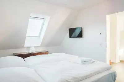 Ein Bett oder Betten in einem Zimmer der Unterkunft Dünenquartier Apartment 10