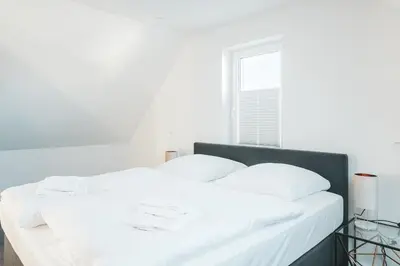 Ein Bett oder Betten in einem Zimmer der Unterkunft Dünenquartier Apartment 10