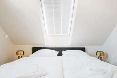 Ein Bett oder Betten in einem Zimmer der Unterkunft Dünenquartier Apartment 17