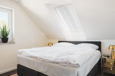 Ein Bett oder Betten in einem Zimmer der Unterkunft Dünenquartier Apartment 17