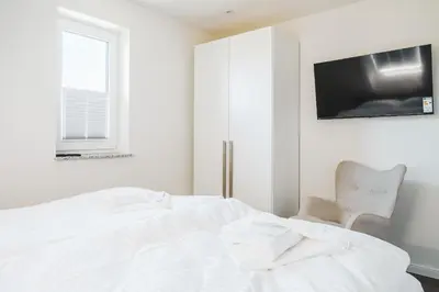 Ein Bett oder Betten in einem Zimmer der Unterkunft Dünenquartier Apartment 18