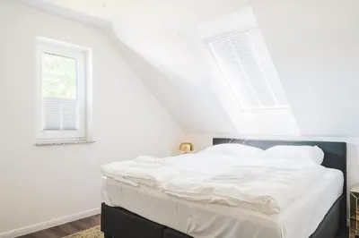 Ein Bett oder Betten in einem Zimmer der Unterkunft Dünenquartier Apartment 21