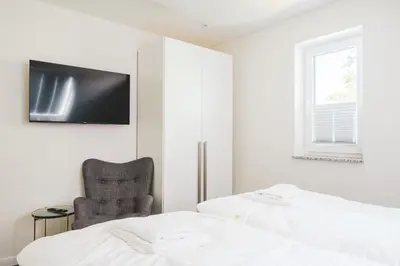 Ein Bett oder Betten in einem Zimmer der Unterkunft Dünenquartier Apartment 21