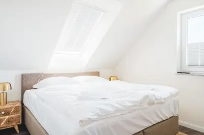 Ein Bett oder Betten in einem Zimmer der Unterkunft Dünenquartier Apartment 26