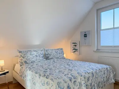 Ein Bett oder Betten in einem Zimmer der Unterkunft Bi de Wisch, OG
