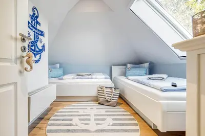 Ein Bett oder Betten in einem Zimmer der Unterkunft FEWO MW8 Zingst - 5min zum Strand - Ostseefeeling & hochwertige Küchenausstattung