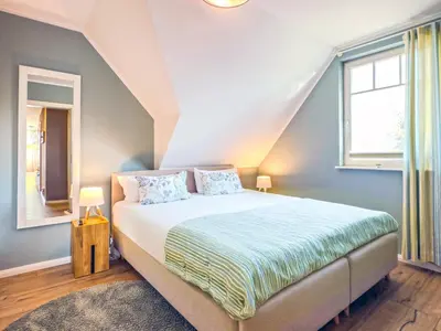 Ein Bett oder Betten in einem Zimmer der Unterkunft Wellenklang
