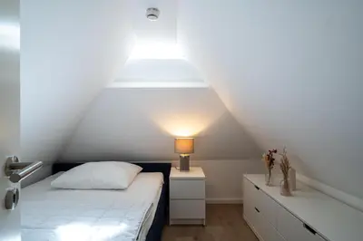 Ein Bett oder Betten in einem Zimmer der Unterkunft Sanddornhus