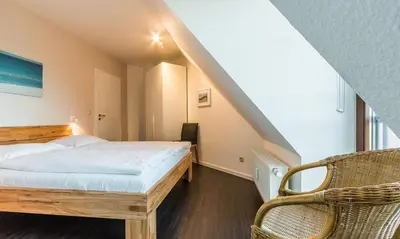 Ein Bett oder Betten in einem Zimmer der Unterkunft Windflüchter, Landhaus Haven Höövt
