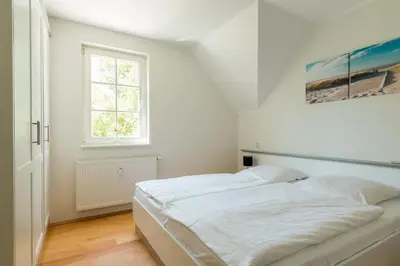 Ein Bett oder Betten in einem Zimmer der Unterkunft Mädesüß 02