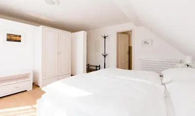 Ein Bett oder Betten in einem Zimmer der Unterkunft Dünenblick 02