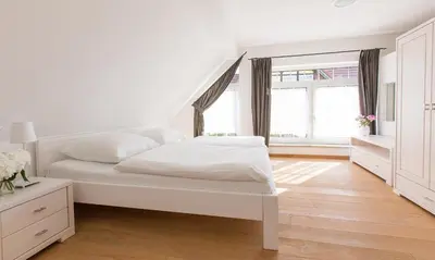Ein Bett oder Betten in einem Zimmer der Unterkunft Dünenblick 02