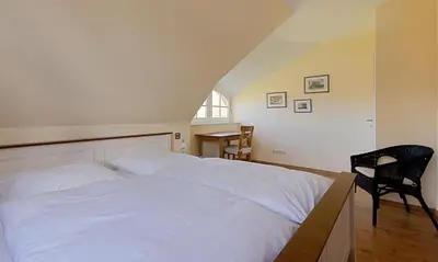 Ein Bett oder Betten in einem Zimmer der Unterkunft Klönhus