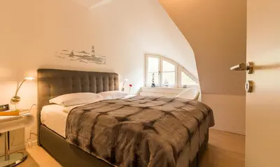 Ein Bett oder Betten in einem Zimmer der Unterkunft Strandidyll
