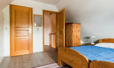 Ein Bett oder Betten in einem Zimmer der Unterkunft Ahrenshooper Landhaus 04