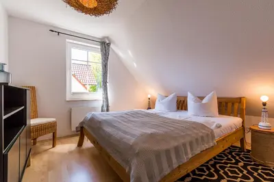 Ein Bett oder Betten in einem Zimmer der Unterkunft Haus Ostseenixe 03