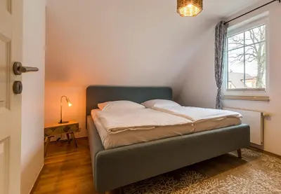 Ein Bett oder Betten in einem Zimmer der Unterkunft Haus Ostseenixe 04