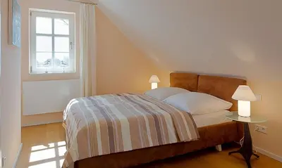 Ein Bett oder Betten in einem Zimmer der Unterkunft Boddensegler