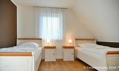 Ein Bett oder Betten in einem Zimmer der Unterkunft Düne 7