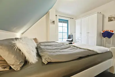 Ein Bett oder Betten in einem Zimmer der Unterkunft Ferienpark Freesenbruch Doppelhaushälfte 11a - Schwalbennest