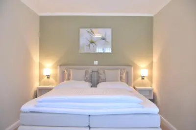 Ein Bett oder Betten in einem Zimmer der Unterkunft Logierhaus Friedrich WE 5 - 