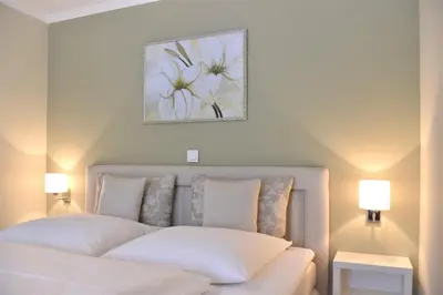 Ein Bett oder Betten in einem Zimmer der Unterkunft Logierhaus Friedrich WE 5 - 