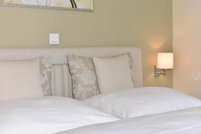 Ein Bett oder Betten in einem Zimmer der Unterkunft Logierhaus Friedrich WE 5 - 