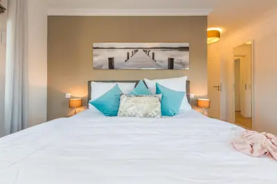 Ein Bett oder Betten in einem Zimmer der Unterkunft Logierhaus Friedrich WE 7 - 