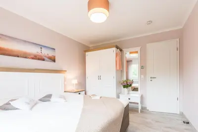 Ein Bett oder Betten in einem Zimmer der Unterkunft Logierhaus Friedrich WE 10 - 