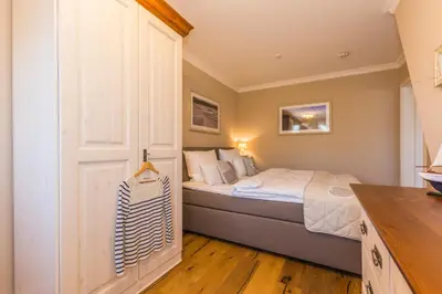 Ein Bett oder Betten in einem Zimmer der Unterkunft Logierhaus Friedrich WE 14 - 