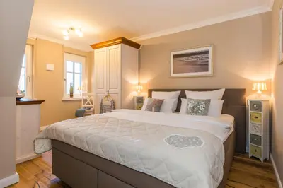 Ein Bett oder Betten in einem Zimmer der Unterkunft Logierhaus Friedrich WE 14 - 