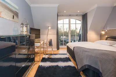 Ein Bett oder Betten in einem Zimmer der Unterkunft Logierhaus Friedrich WE 17 - 