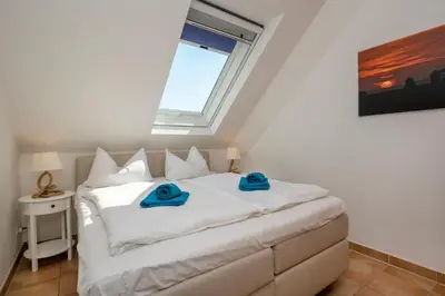 Ein Bett oder Betten in einem Zimmer der Unterkunft Residenz am Strand Wohnung 1-17